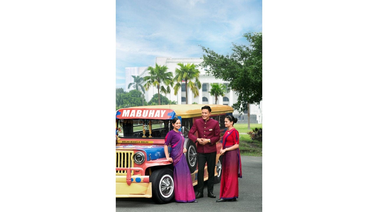Air India cabin crew strikes a pose with a jeepney, Manila’s mode of public transport and a cultural icon