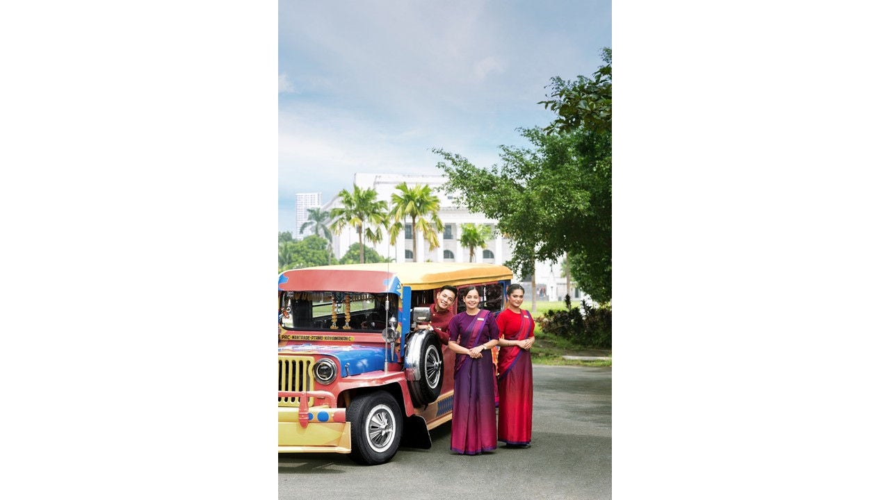 Air India cabin crew strikes a pose with a jeepney, Manila’s mode of public transport and a cultural icon