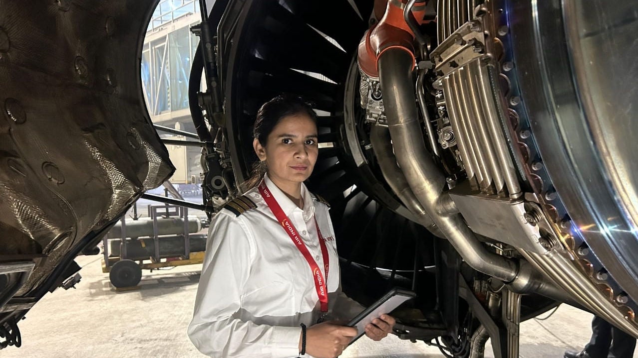 Air India engineer working on an aircraft engine