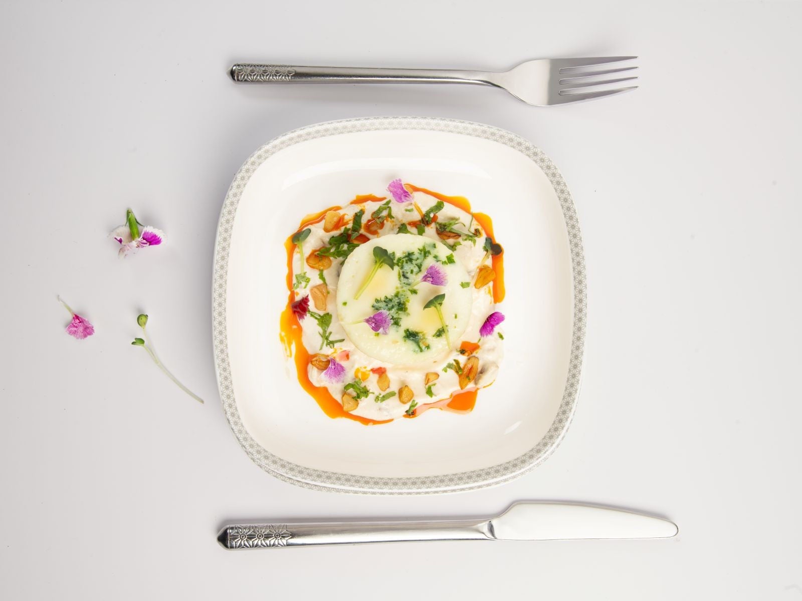 Turkish Eggs – Steamed eggs with garlic yoghurt, roast chili butter, fresh coriander and crispy garlic slivers